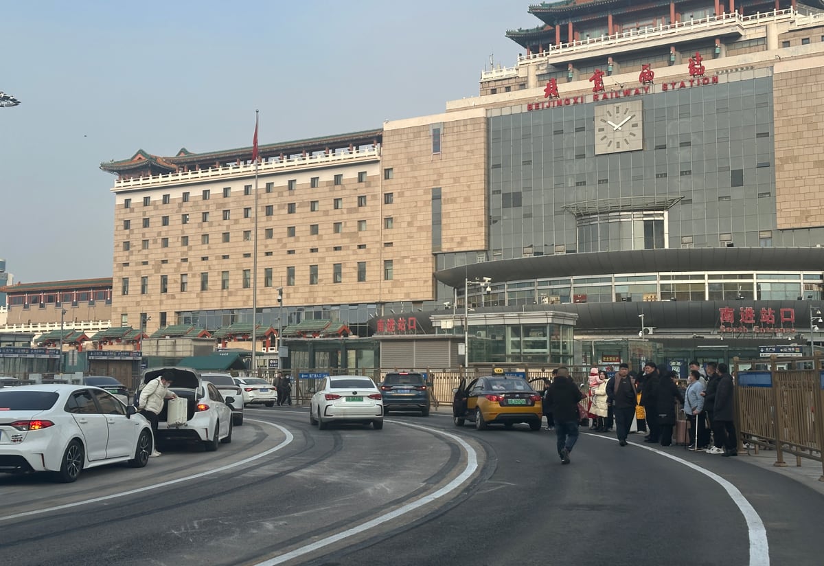 South entrance of Beijing West Railway Station with taxis and travellers.
