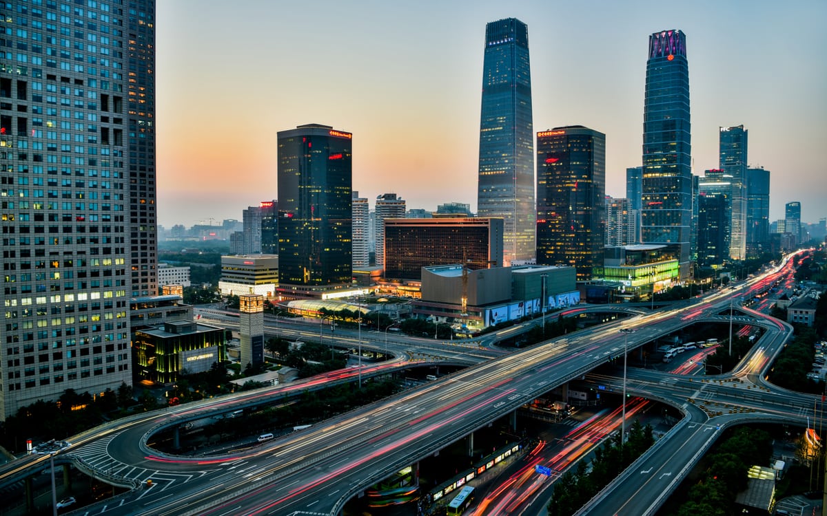 Beijing's CBD skyline and elevated roads at dusk.