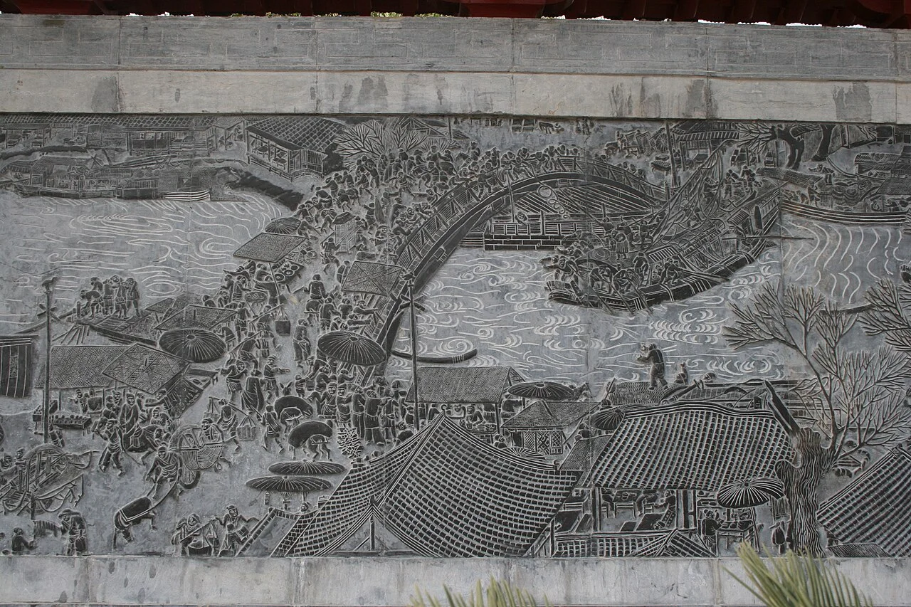 A modern relief in Qingming Riverside Landscape Garden showing the crowded painted Hongqiao scene.