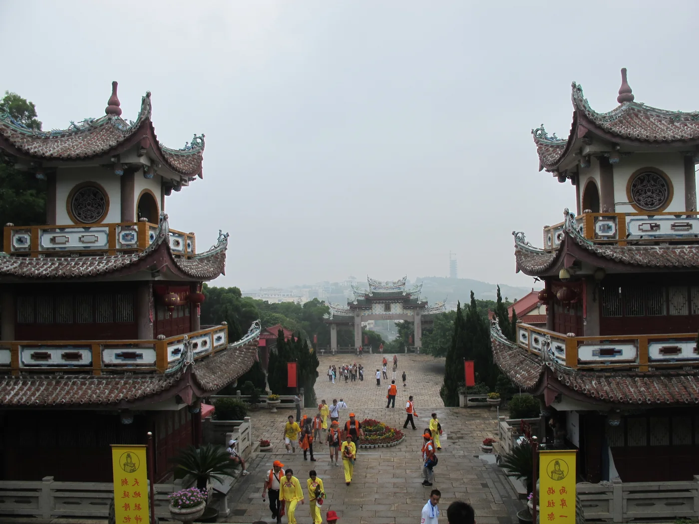 A view down a stepped axis in the Meizhou Mazu Ancestral Temple complex, framed by two multi-storey buildings.