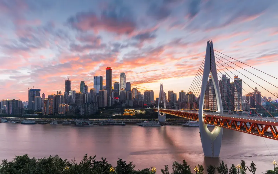 Chongqing skyline and river bridge at sunset