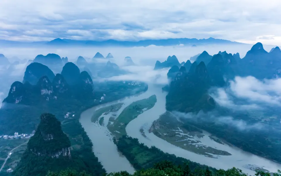 Morning mist over the Li River among karst peaks