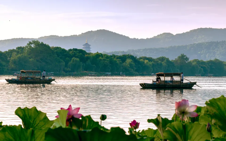 Boats on West Lake in Hangzhou with lotus in the foreground