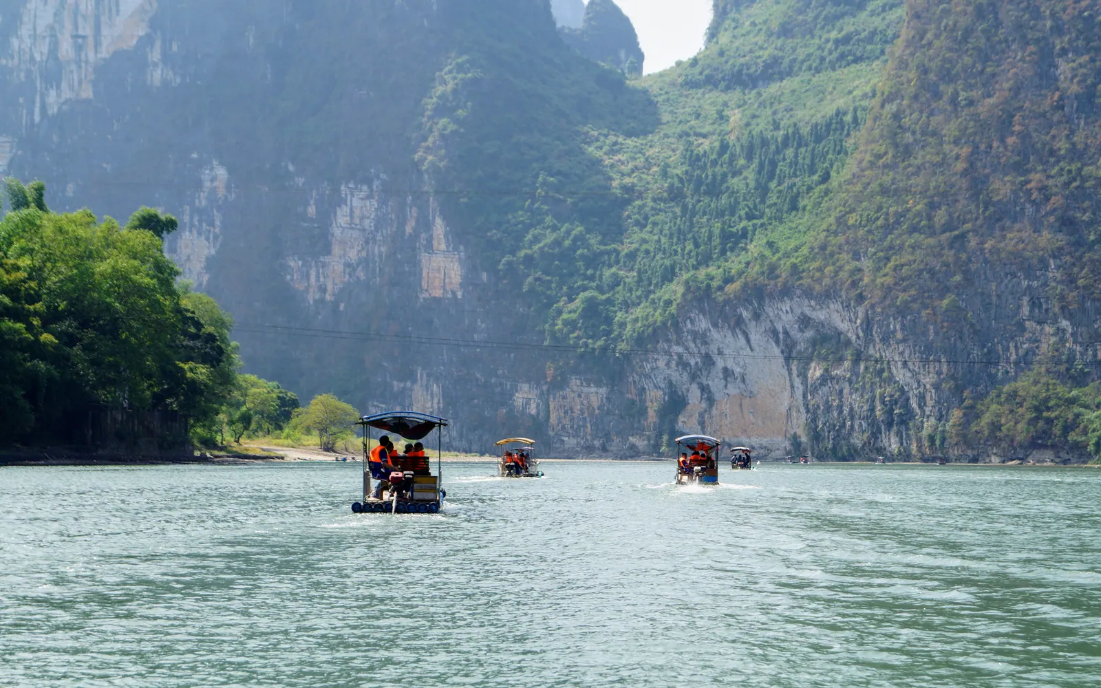 Boats on the Li River between karst cliffs