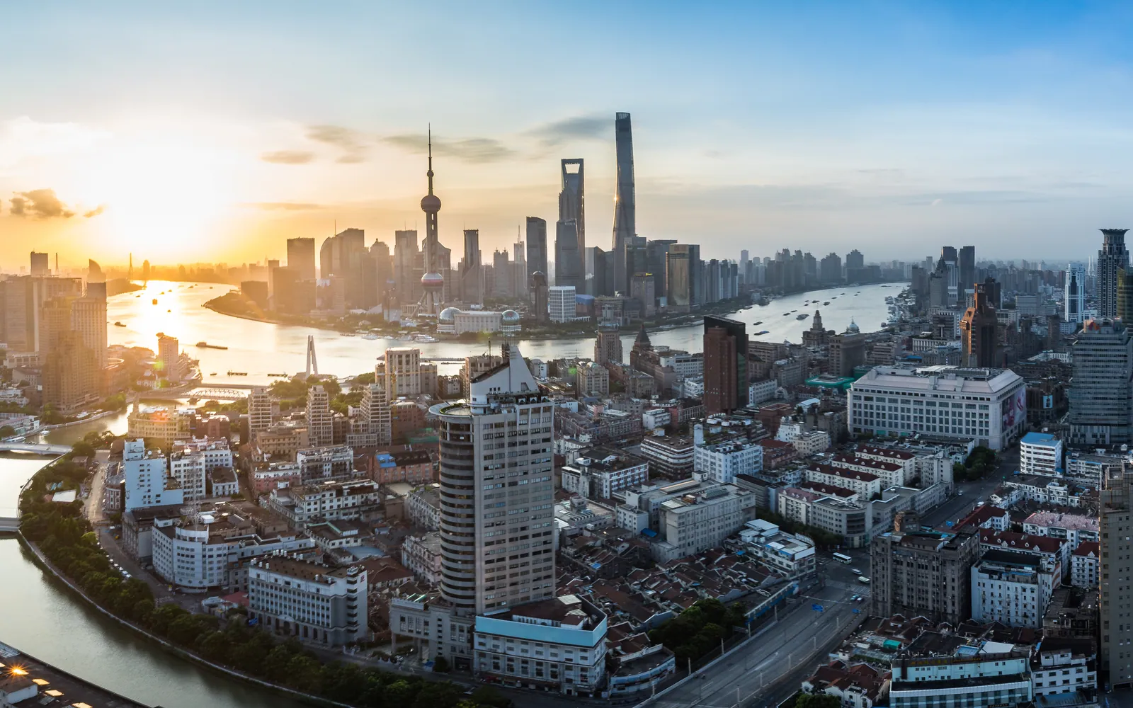 Old Shanghai rooftops facing Lujiazui at sunset