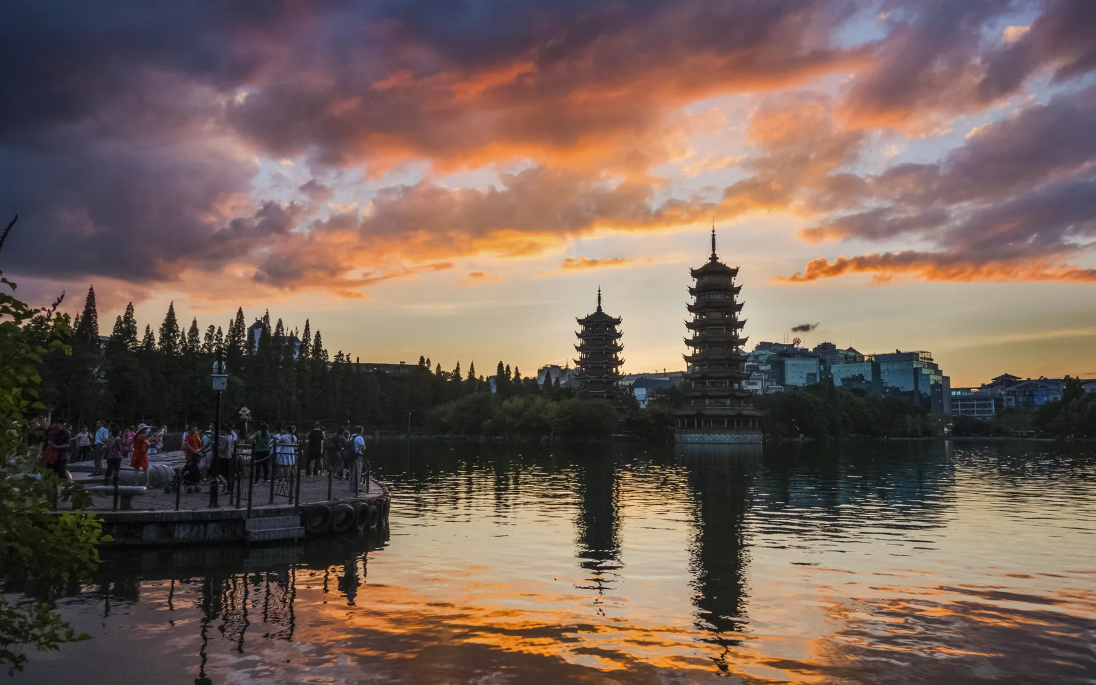 Sun and Moon Pagodas reflected in Guilin's lake at sunset
