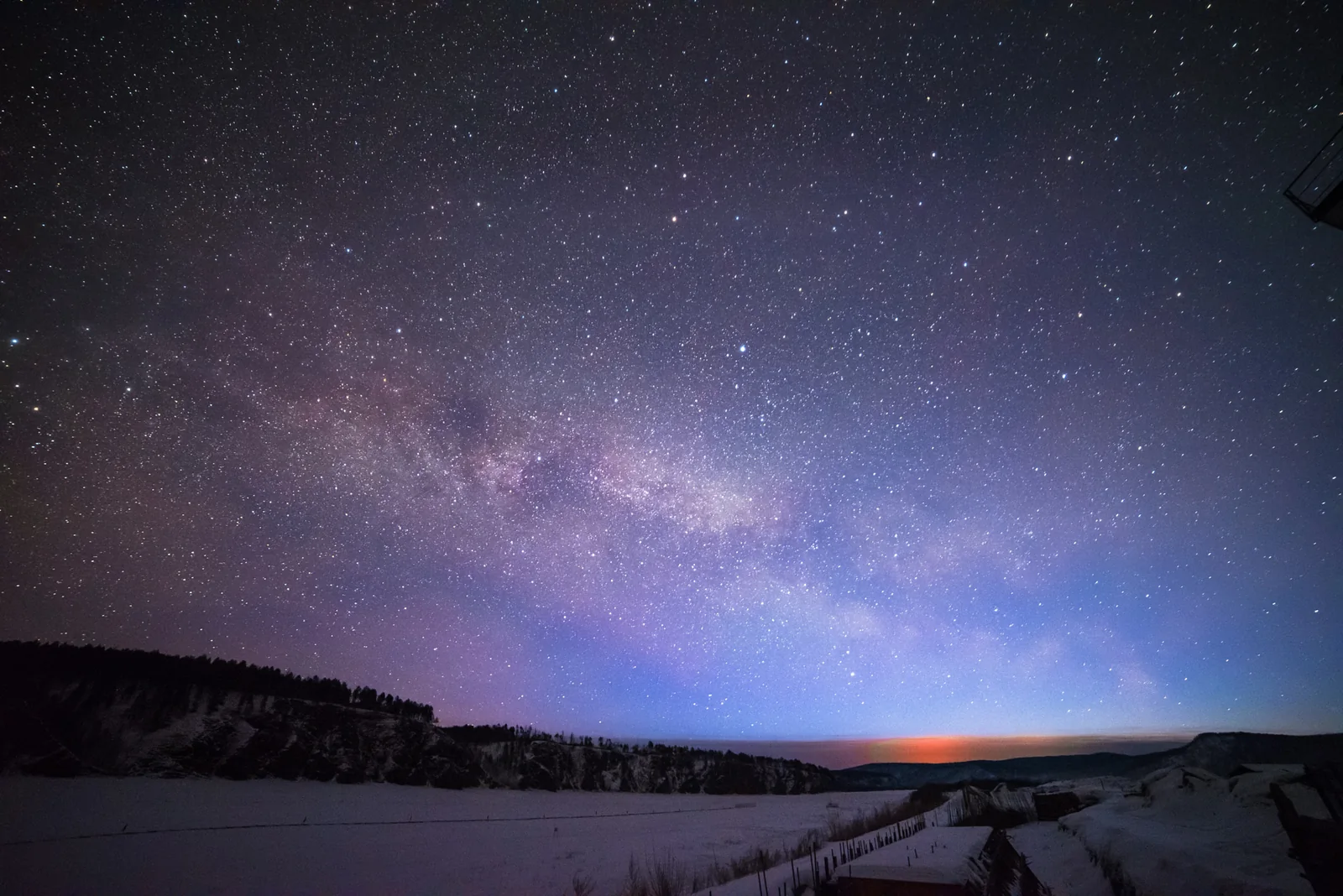 Starry winter dawn over snowy land near Beihong Village
