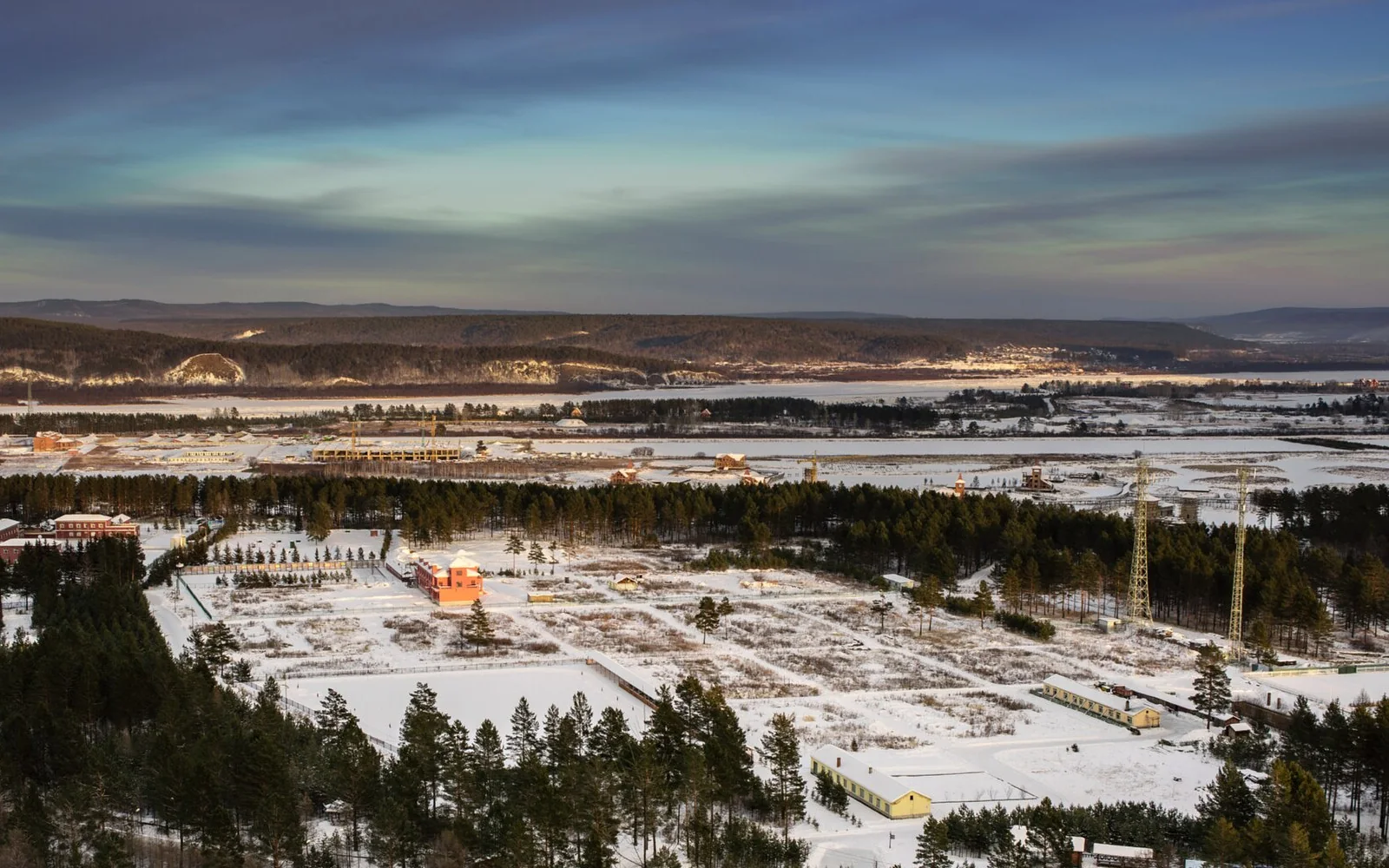 Snow-covered settlement and forest in the Mohe area