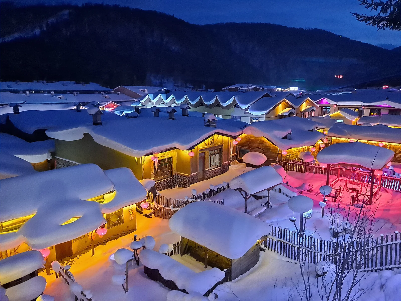 Snow-covered rooftops in China Snow Town at blue hour