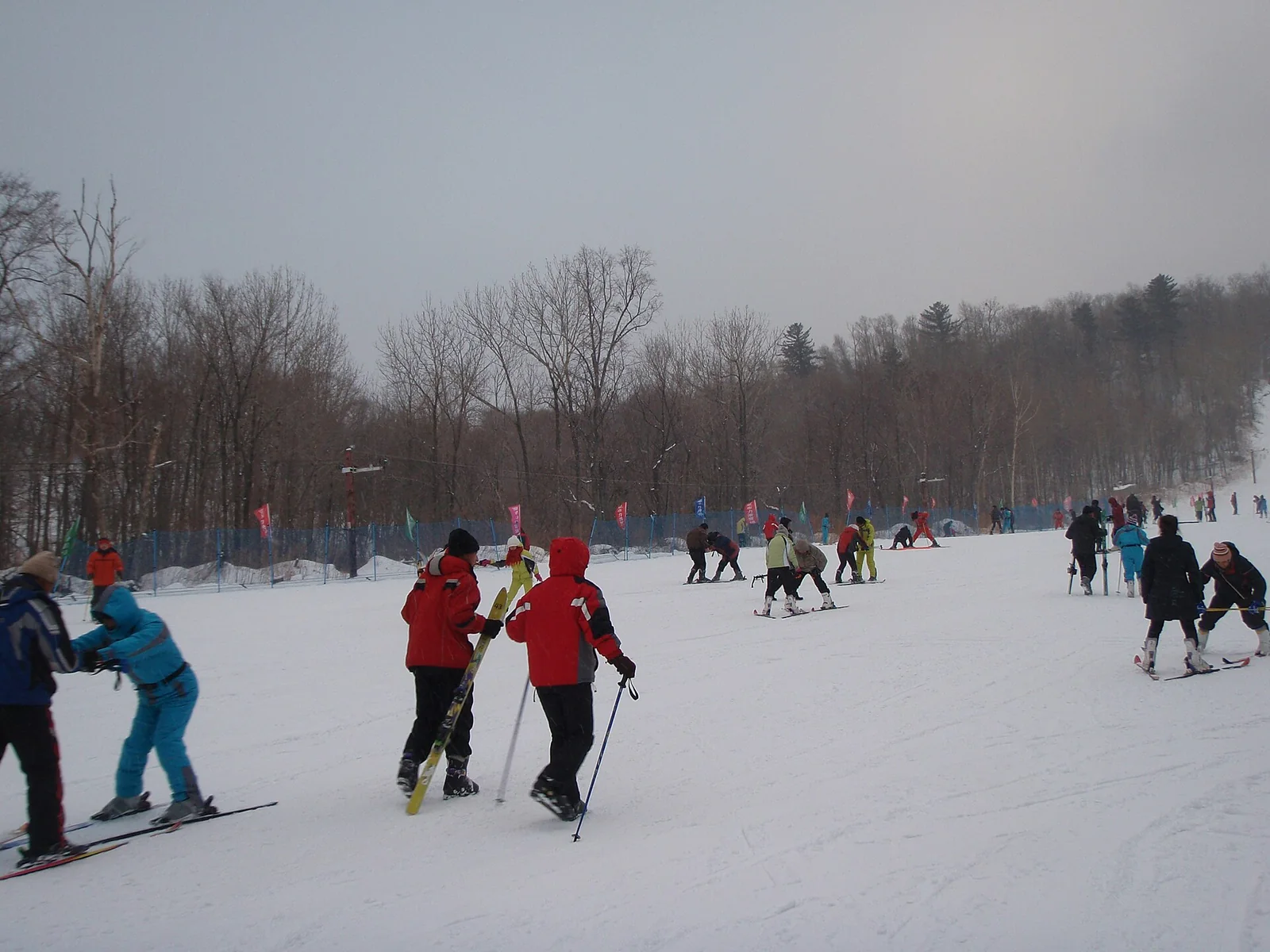 Skiers on a snow-covered beginner slope in Yabuli