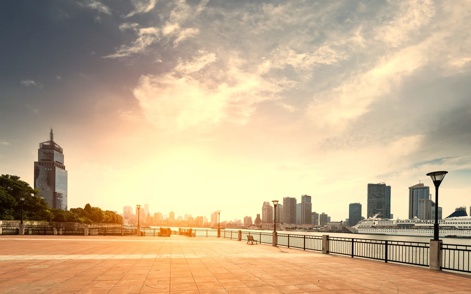 A quiet Bund promenade and Huangpu River at sunrise