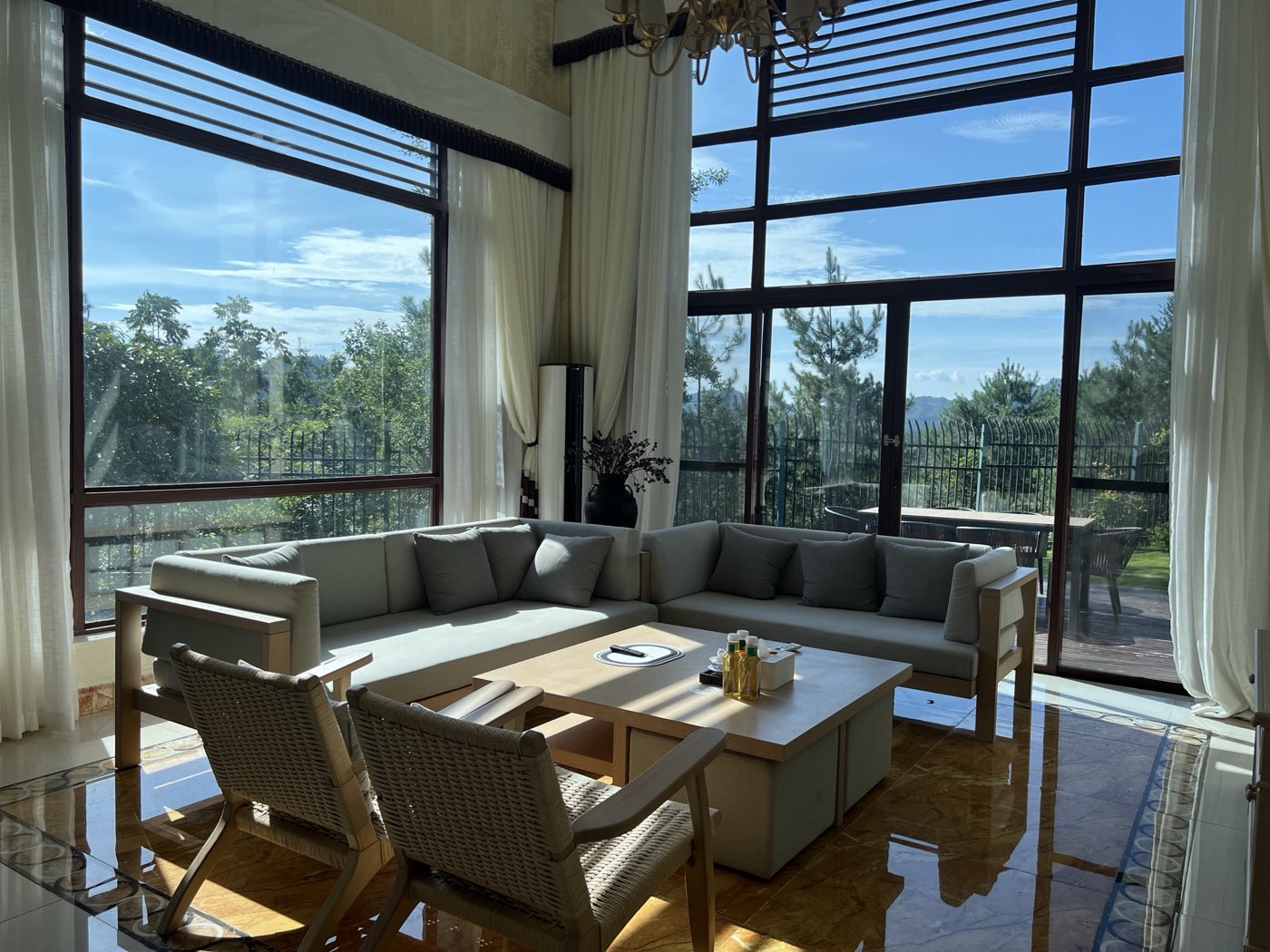 Sunlit living room with full-height windows in the premium-stay set