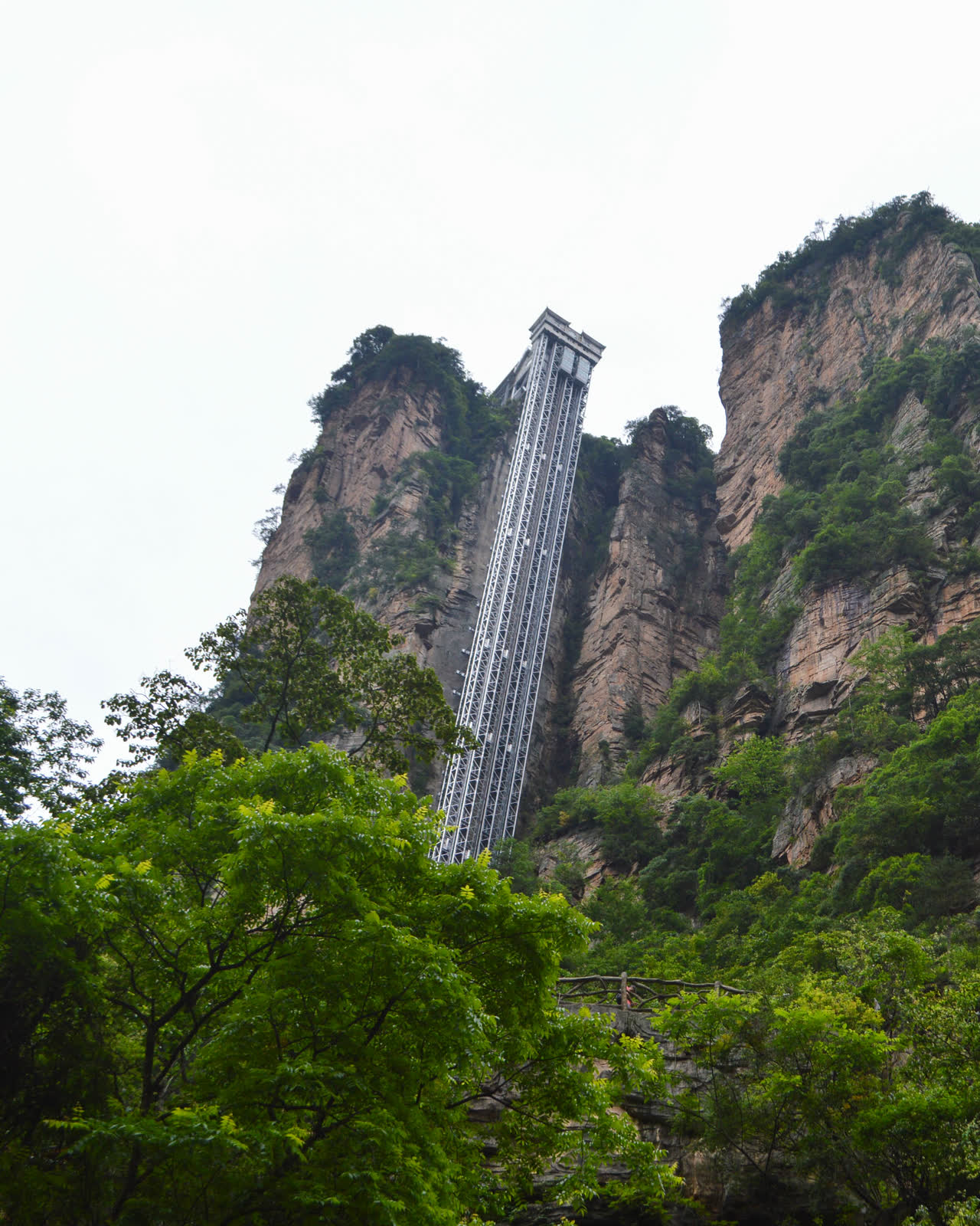 The Bailong Elevator rising against a sandstone cliff in Zhangjiajie National Forest Park